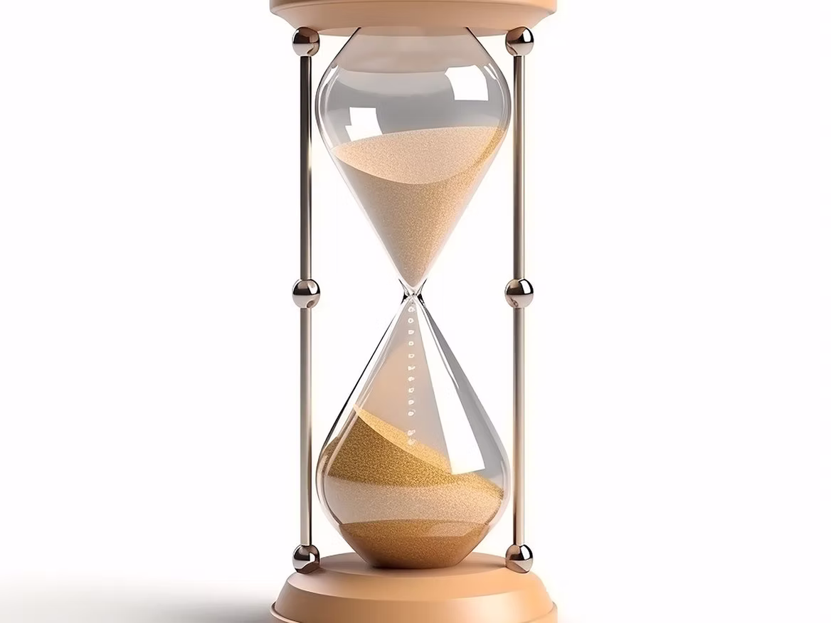 Hourglass on table symbolizing the historical evolution of massage therapy across cultures and centuries