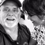 Woman embracing elderly man with peaceful expression, symbolizing emotional healing through Reiki for PTSD recovery