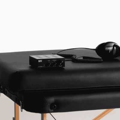 Vibroacoustic therapy table with sound equipment and headphones used in sound healing and massage sessions in Olympia WA
